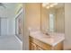 Bathroom with a vanity area, sink and a glimpse of the Primary bedroom entrance offers a functional layout at 340 Bermuda Ct # 5, Venice, FL 34293