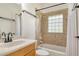 Well-lit bathroom features a shower-tub combo with decorative tiled walls and granite countertops at 340 Bermuda Ct # 5, Venice, FL 34293