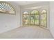 Bedroom with carpet and arched windows with plantation shutters at 340 Bermuda Ct # 5, Venice, FL 34293