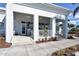 Inviting clubhouse entrance with elegant columns, ceiling fans, and beautiful landscaping, creating a welcoming atmosphere at 340 Bermuda Ct # 5, Venice, FL 34293