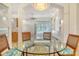 Bright and spacious dining area with a glass table that has great pool views at 340 Bermuda Ct # 5, Venice, FL 34293
