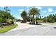 Scenic view of an ornate roundabout entrance with lush landscaping and manicured grounds at 340 Bermuda Ct # 5, Venice, FL 34293