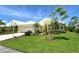 Inviting yellow single-Gathering home with white roof, lush lawn, and tropical landscaping at 340 Bermuda Ct # 5, Venice, FL 34293