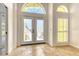 Bright foyer features tile flooring, arch window, and double glass entry doors at 340 Bermuda Ct # 5, Venice, FL 34293