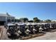 Numerous golf carts lined up, ready for a day on the course, highlighting the community's golf-centric lifestyle at 340 Bermuda Ct # 5, Venice, FL 34293