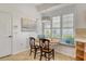 Kitchen dining nook with built-in seating under a large bay window at 340 Bermuda Ct # 5, Venice, FL 34293