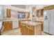 Bright kitchen with island, stainless steel appliances and ample cabinet space at 340 Bermuda Ct # 5, Venice, FL 34293