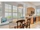 Kitchen nook with bay windows for natural light with decorative pillows and lighting at 340 Bermuda Ct # 5, Venice, FL 34293