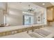 Bright kitchen with white countertop open to the living area and sliding glass doors to screened lanai with pool at 340 Bermuda Ct # 5, Venice, FL 34293