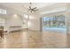Open living room with tile floor, high ceilings, arched windows, view of lanai and pool at 340 Bermuda Ct # 5, Venice, FL 34293
