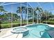 Relaxing pool and hot tub in screened lanai with views of the green golf course at 340 Bermuda Ct # 5, Venice, FL 34293