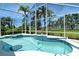 Sparkling pool and spa with mosaic tile accents and screened enclosure overlooking the golf course at 340 Bermuda Ct # 5, Venice, FL 34293