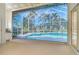 Enclosed pool featuring a spa with stunning views of surrounding lush greenery ensures year-round enjoyment and relaxation at 340 Bermuda Ct # 5, Venice, FL 34293