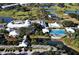Beautiful aerial view of a community clubhouse with a sparkling blue swimming pool and lush tropical surroundings at 340 Bermuda Ct # 5, Venice, FL 34293