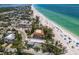 Coastal home near the beach with tropical trees, and nearby beach access at 3720 Gulf Dr, Holmes Beach, FL 34217