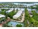 Aerial view of townhomes with tennis court and waterfront in a gated community at 3954 Hamilton Club Cir # 14, Sarasota, FL 34242