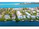 Stunning aerial view showcases the waterfront property with boat docks and ocean views at 3954 Hamilton Club Cir # 14, Sarasota, FL 34242
