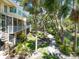 Tropical garden, mature trees, and a charming walkway; the rear of the building features spiral staircases at 3954 Hamilton Club Cir # 14, Sarasota, FL 34242