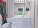 Bathroom featuring a white vanity, decorative mirror, soft lighting and a bright, airy atmosphere at 3954 Hamilton Club Cir # 14, Sarasota, FL 34242