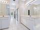 Elegant bathroom with double sinks, a long mirror, and a view into the room beyond at 3954 Hamilton Club Cir # 14, Sarasota, FL 34242