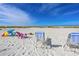 Expansive beach view with colorful chairs and blue sky, ideal for relaxation and enjoying the coastal lifestyle at 3954 Hamilton Club Cir # 14, Sarasota, FL 34242