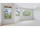 Cozy bedroom featuring neutral walls, large windows, and a ceiling fan for added comfort at 3954 Hamilton Club Cir # 14, Sarasota, FL 34242