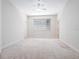Neutral bedroom with a ceiling fan and large window at 3954 Hamilton Club Cir # 14, Sarasota, FL 34242
