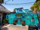 Eclectic outdoor scene with Siesta Key sign, surfboards, and colorful decor at 3954 Hamilton Club Cir # 14, Sarasota, FL 34242