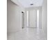 Bright, airy foyer with white tile flooring and a classic white front door at 3954 Hamilton Club Cir # 14, Sarasota, FL 34242