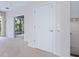 Bright hallway leads to an outdoor balcony with neutral carpet and white trim at 3954 Hamilton Club Cir # 14, Sarasota, FL 34242
