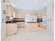 Bright kitchen with an island, appliances, tiled flooring, and plenty of cabinet space at 3954 Hamilton Club Cir # 14, Sarasota, FL 34242