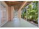 Screened outdoor patio with tropical plants and view of the main building at 3954 Hamilton Club Cir # 14, Sarasota, FL 34242