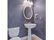 Stylish powder room with a pedestal sink, decorative mirror, and toilet at 3954 Hamilton Club Cir # 14, Sarasota, FL 34242