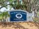 Prominent sign for The Out-of-Door Academy, established in 1924, surrounded by lush greenery and mature trees at 3954 Hamilton Club Cir # 14, Sarasota, FL 34242