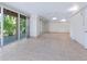 Large tiled sunroom with sliding glass doors that overlook the tropical exterior at 3954 Hamilton Club Cir # 14, Sarasota, FL 34242