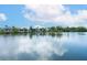 Serene waterfront view showcasing calm water reflecting a bright sky with scattered clouds at 3954 Hamilton Club Cir # 14, Sarasota, FL 34242