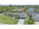A high angle shows a landscaped home with a gray roof, lawn, and waterway behind the property at 4396 Pasadena Cir, Sarasota, FL 34233