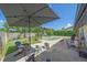 Enjoy backyard views with a custom pool, patio, fire pit, lounge chairs, and more at 4396 Pasadena Cir, Sarasota, FL 34233