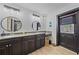 Bathroom featuring granite countertops, wood-look flooring, and a black trimmed door at 4396 Pasadena Cir, Sarasota, FL 34233