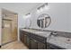 Bathroom featuring dual sinks, granite countertops, and a glass enclosed shower at 4396 Pasadena Cir, Sarasota, FL 34233