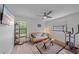 Bedroom featuring a futon, ceiling fan, and two windows offering ample natural light at 4396 Pasadena Cir, Sarasota, FL 34233