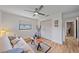 Bedroom featuring a ceiling fan, wood-look flooring, and closet with a view to the hallway at 4396 Pasadena Cir, Sarasota, FL 34233