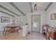 Cozy dining area featuring beamed ceilings, a pendant light, and wood-look tile flooring at 4396 Pasadena Cir, Sarasota, FL 34233