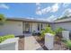 Charming front entrance with garden beds and greenery adding to the curb appeal of this home at 4396 Pasadena Cir, Sarasota, FL 34233