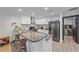 Modern kitchen with granite countertops, breakfast bar, and white cabinetry with stainless steel hardware at 4396 Pasadena Cir, Sarasota, FL 34233