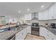 Updated kitchen featuring granite countertops, stainless steel appliances, and sleek white cabinets at 4396 Pasadena Cir, Sarasota, FL 34233