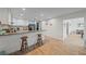 Open kitchen design featuring breakfast bar with granite counters and wooden stools at 4396 Pasadena Cir, Sarasota, FL 34233