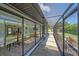 View of the screened lanai overlooking the backyard with mature landscaping and patio at 4396 Pasadena Cir, Sarasota, FL 34233