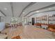 Spacious living room with beamed ceilings, lots of natural light, and wood-look tile flooring at 4396 Pasadena Cir, Sarasota, FL 34233