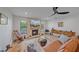 Bright living room featuring stone fireplace, modern décor, and a ceiling fan at 4396 Pasadena Cir, Sarasota, FL 34233